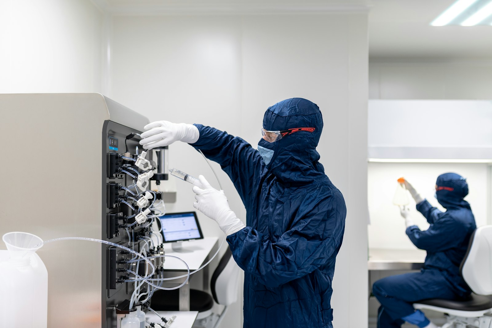 Cleanroom technicians operating process equipment